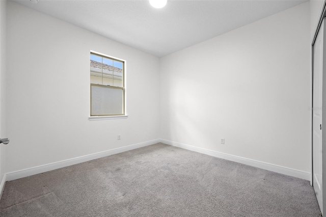 unfurnished room featuring carpet