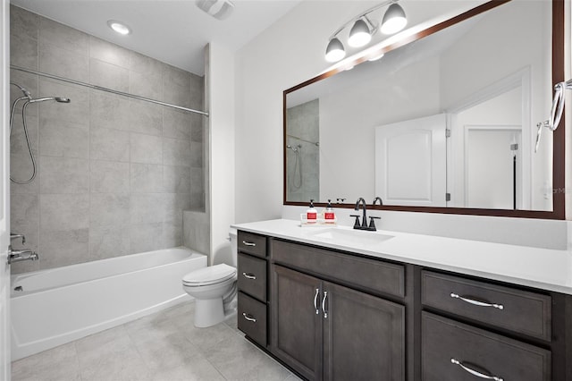 full bathroom featuring vanity, tiled shower / bath combo, and toilet