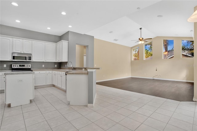 kitchen featuring white cabinets, appliances with stainless steel finishes, kitchen peninsula, and ceiling fan