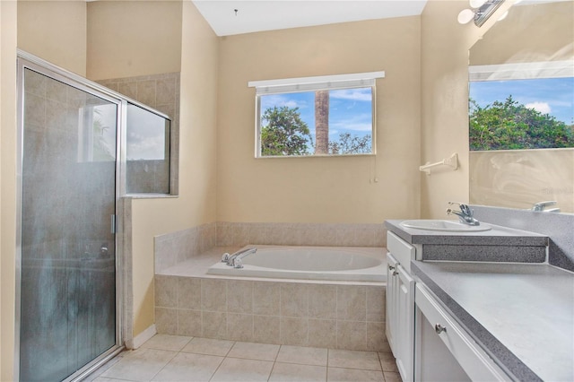 bathroom featuring tile patterned flooring, vanity, and shower with separate bathtub