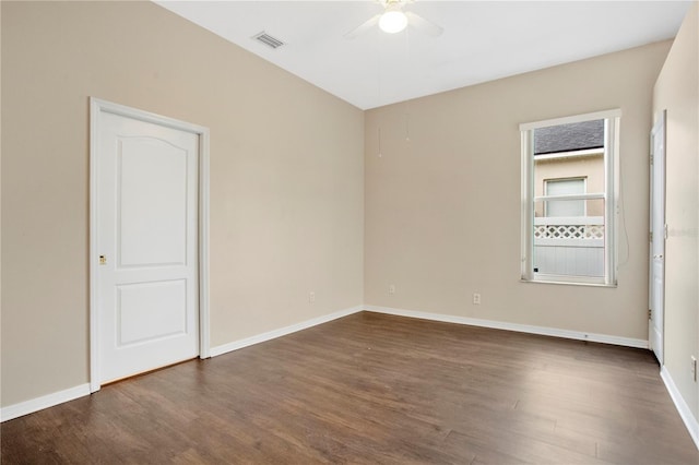 empty room with dark hardwood / wood-style flooring and ceiling fan