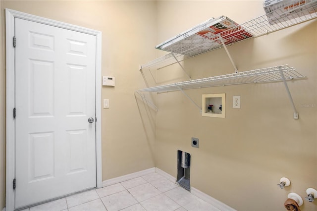 clothes washing area featuring washer hookup, electric dryer hookup, and light tile patterned flooring