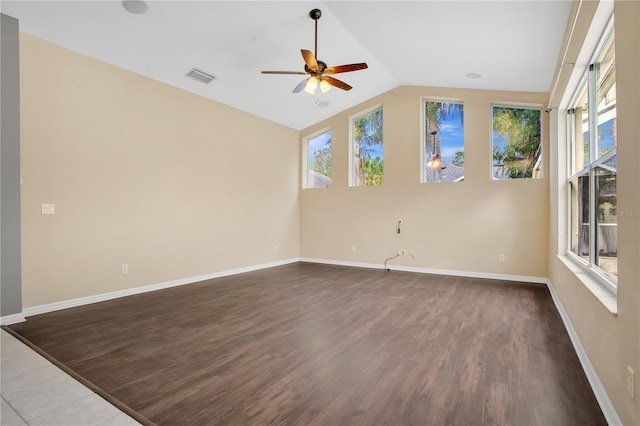 empty room with hardwood / wood-style flooring, ceiling fan, a healthy amount of sunlight, and lofted ceiling