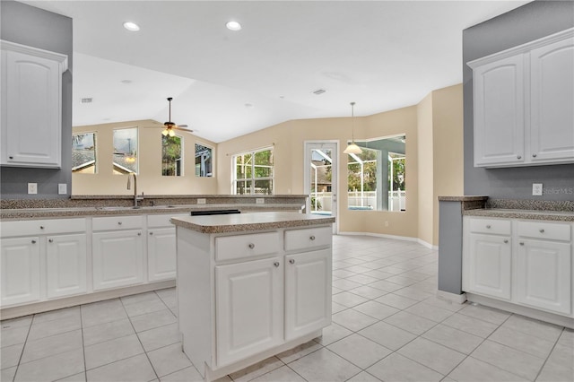 kitchen featuring sink, vaulted ceiling, ceiling fan, decorative light fixtures, and white cabinetry