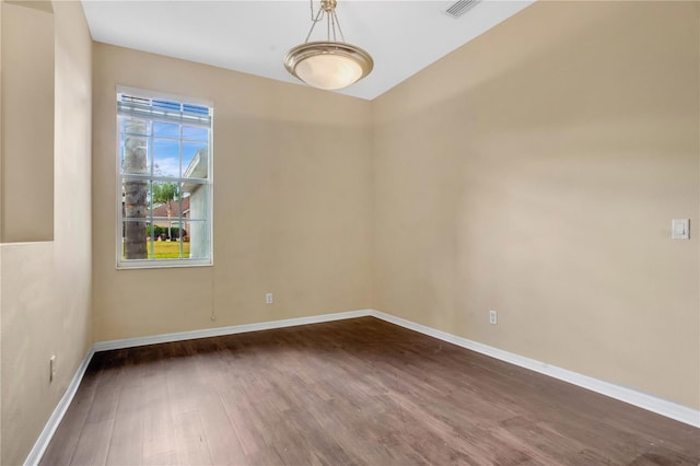 unfurnished room featuring dark hardwood / wood-style floors