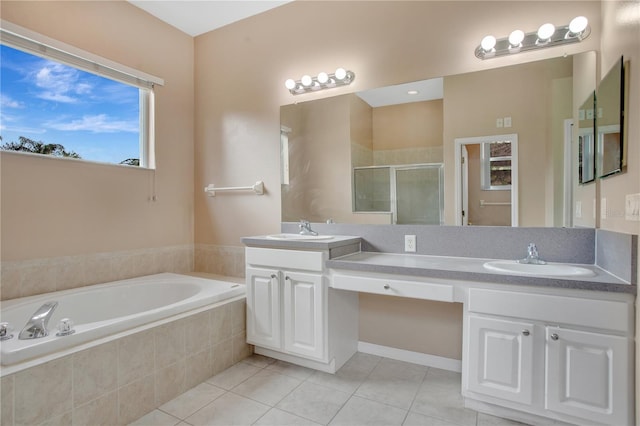 bathroom featuring tile patterned flooring, vanity, and shower with separate bathtub