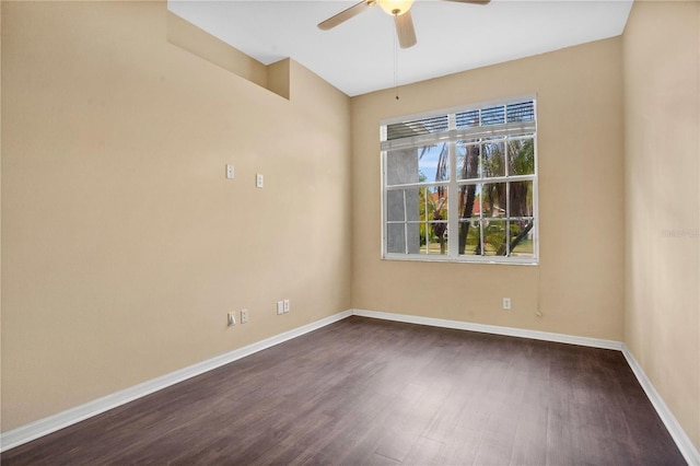 empty room with ceiling fan and dark wood-type flooring