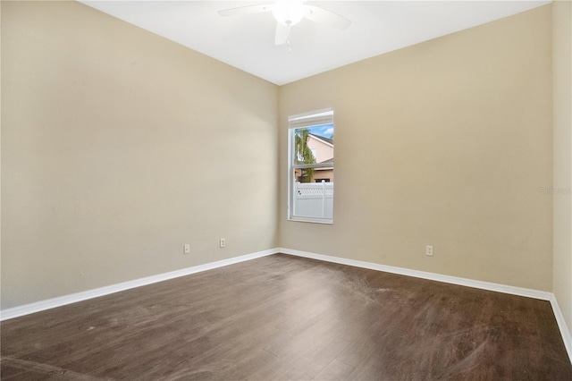 empty room with ceiling fan and dark hardwood / wood-style flooring