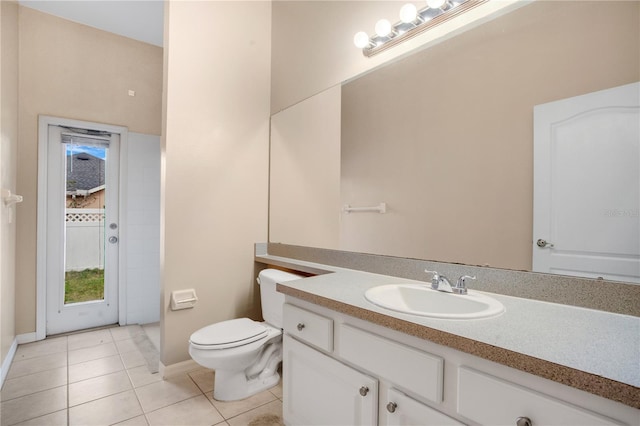 bathroom featuring tile patterned floors, vanity, and toilet