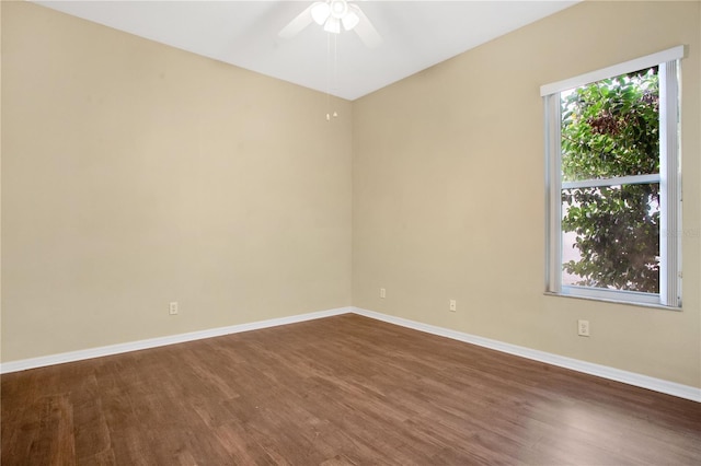 spare room with ceiling fan and dark hardwood / wood-style floors