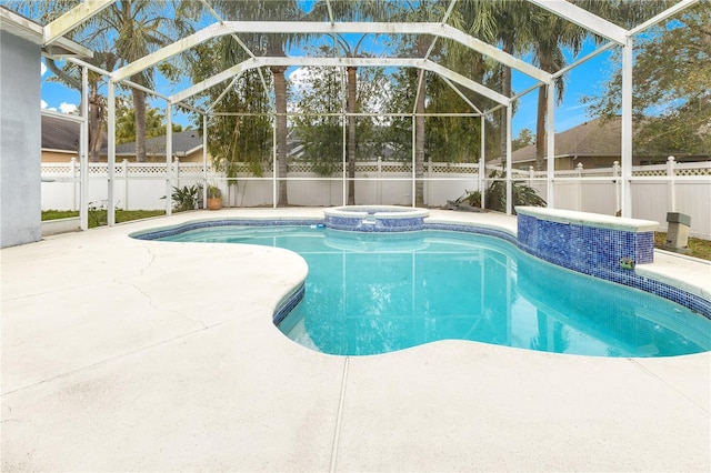 view of swimming pool featuring an in ground hot tub, a patio area, and a lanai