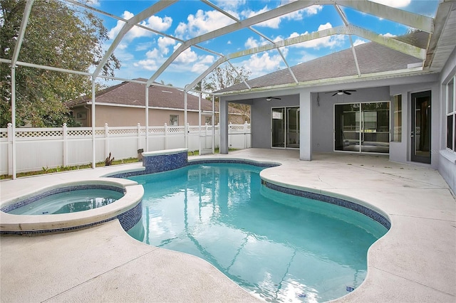 view of swimming pool featuring an in ground hot tub, a lanai, ceiling fan, and a patio area