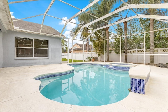 view of pool with an in ground hot tub, a lanai, and a patio area