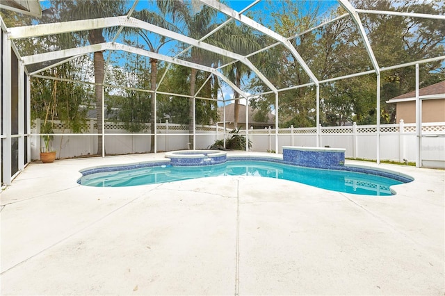 view of pool with glass enclosure, an in ground hot tub, and a patio