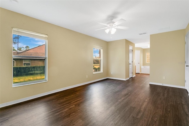 empty room featuring ceiling fan and dark hardwood / wood-style flooring