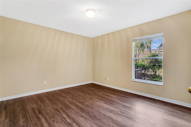 empty room featuring dark hardwood / wood-style flooring