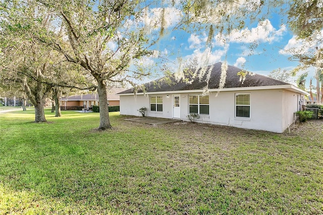 back of house with a yard