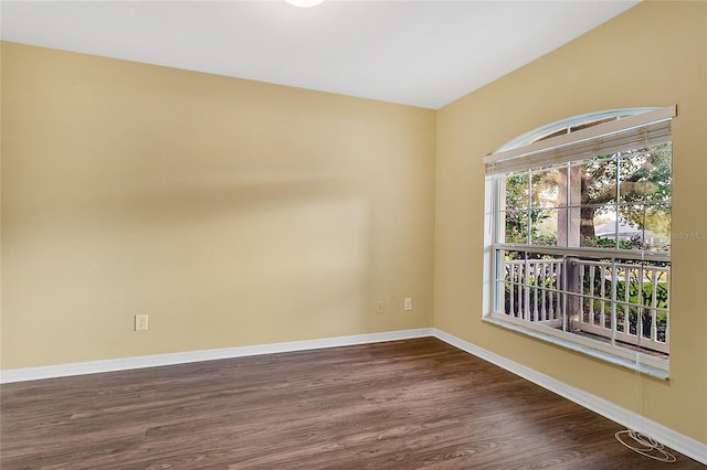 spare room with dark hardwood / wood-style floors