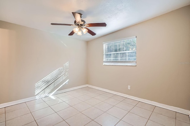 unfurnished room with ceiling fan and light tile patterned floors