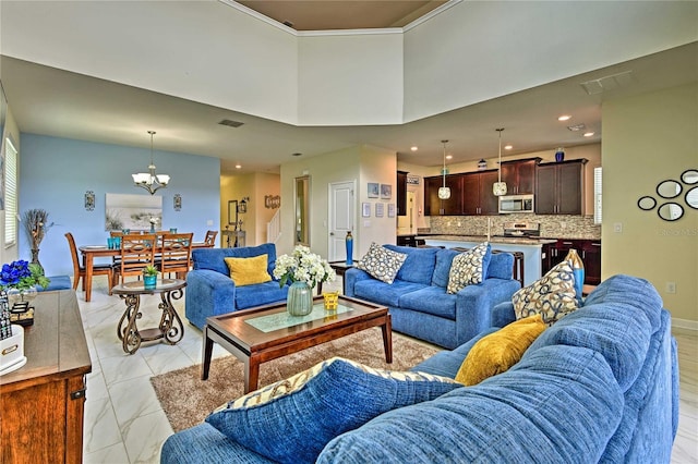 living room with a high ceiling and a notable chandelier