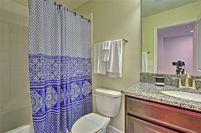 full bathroom with vanity, shower / bath combo, and toilet