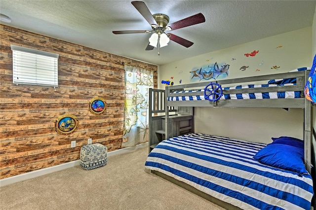 1636 Moon Valley Dr, Davenport, FL 33896 - bedroom featuring wood walls, carpet floors, a textured ceiling, and a ceiling fan