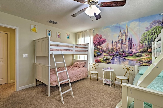 bedroom featuring ceiling fan, carpet, and a textured ceiling