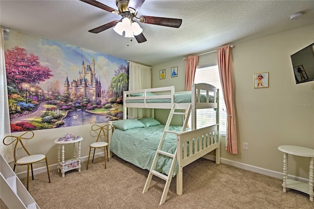 carpeted bedroom featuring ceiling fan and a textured ceiling