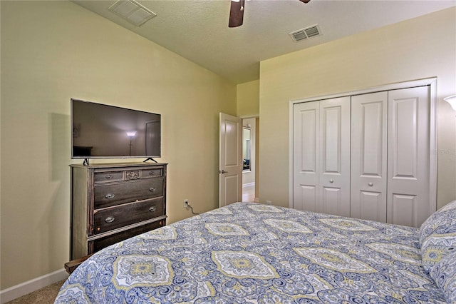 carpeted bedroom with ceiling fan and a closet