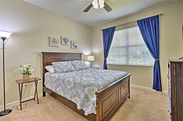 bedroom featuring ceiling fan and light carpet