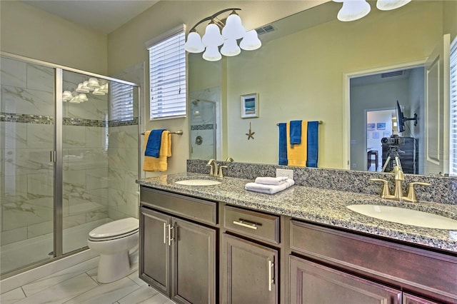 bathroom featuring vanity, toilet, and walk in shower