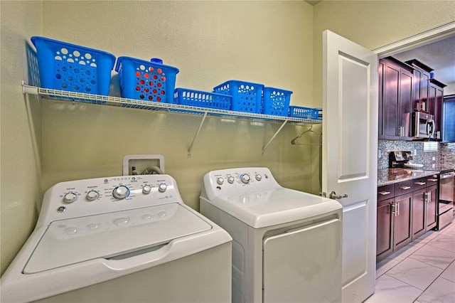 1636 Moon Valley Dr, Davenport, FL 33896 - washroom with washing machine and dryer and light marble finish floors