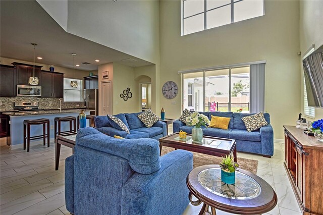 living room featuring a high ceiling