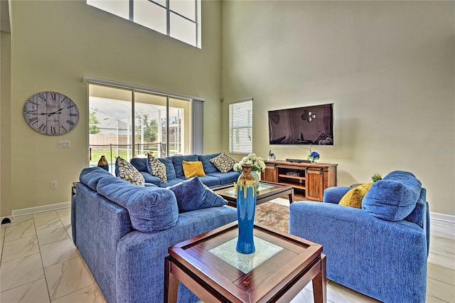 1636 Moon Valley Dr, Davenport, FL 33896 - living room featuring light marble finish floors and a high ceiling
