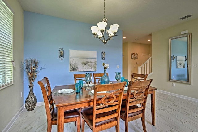 1636 Moon Valley Dr, Davenport, FL 33896 - dining space with light marble finish floors, a chandelier, stairs, and recessed lighting
