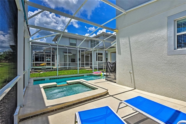 view of pool with a lanai, a patio area, and an in ground hot tub