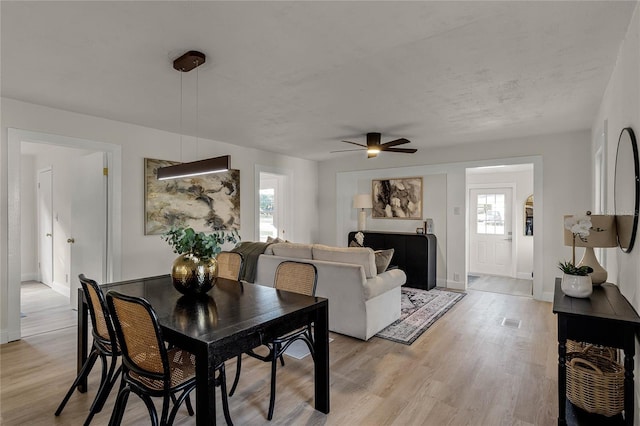 dining area with ceiling fan, light hardwood / wood-style floors, and plenty of natural light