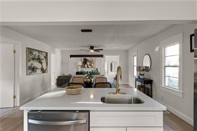 kitchen with dishwasher, white cabinetry, ceiling fan, and sink