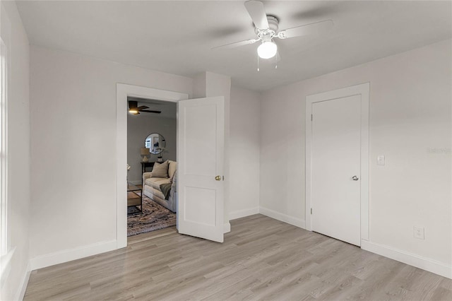 unfurnished bedroom with ceiling fan and light hardwood / wood-style flooring