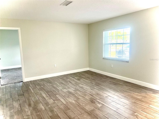 spare room with dark hardwood / wood-style flooring