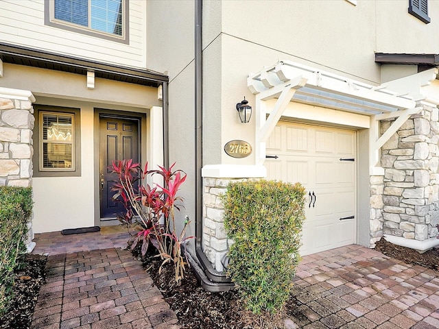 view of exterior entry featuring a garage