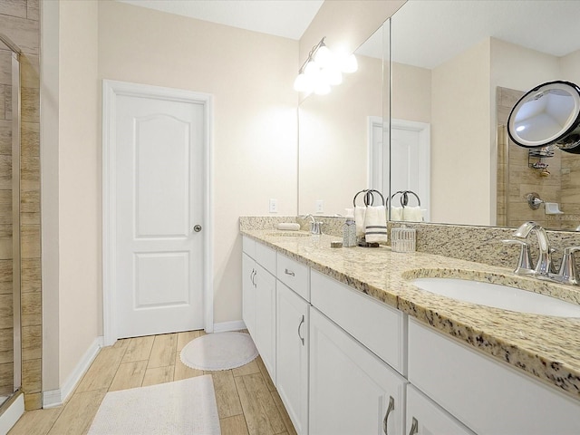 bathroom featuring vanity and a shower with shower door