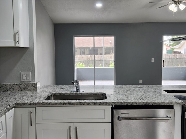 kitchen with white cabinets, plenty of natural light, and a sink