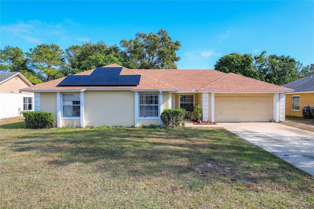 ranch-style house featuring solar panels, a garage, and a front lawn