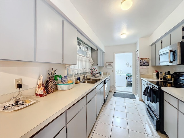 kitchen featuring gray cabinetry, light tile patterned flooring, sink, and black range with electric cooktop