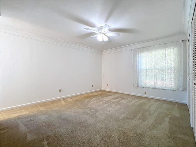 unfurnished room with light carpet, ceiling fan, and crown molding