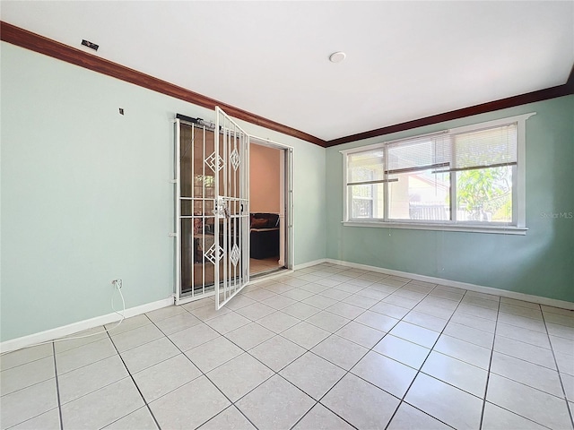 tiled empty room featuring ornamental molding