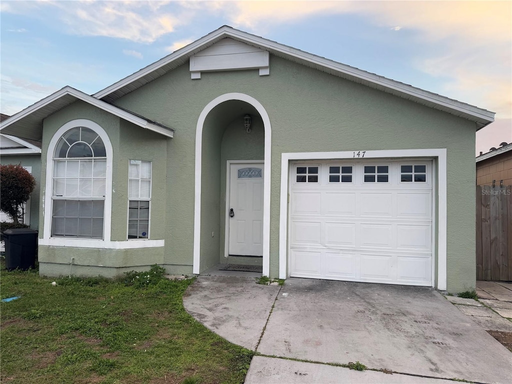 single story home featuring a garage