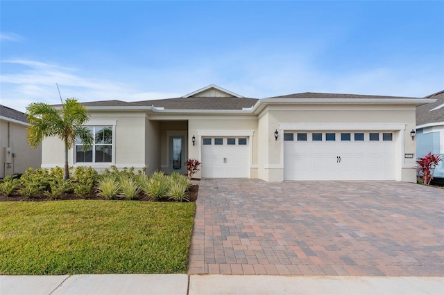 view of front of house featuring a garage and a front yard