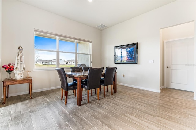 dining area featuring light wood-type flooring